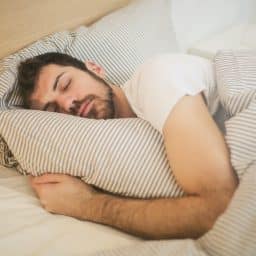Man sleeping comfortably in bed.