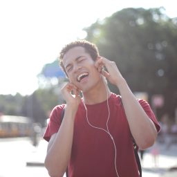 Man listening to headphones and singing along.