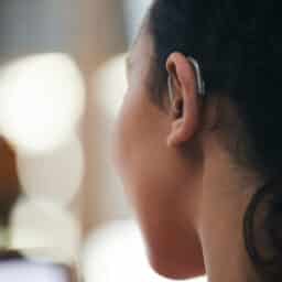 Close up of a hearing aid on an ear