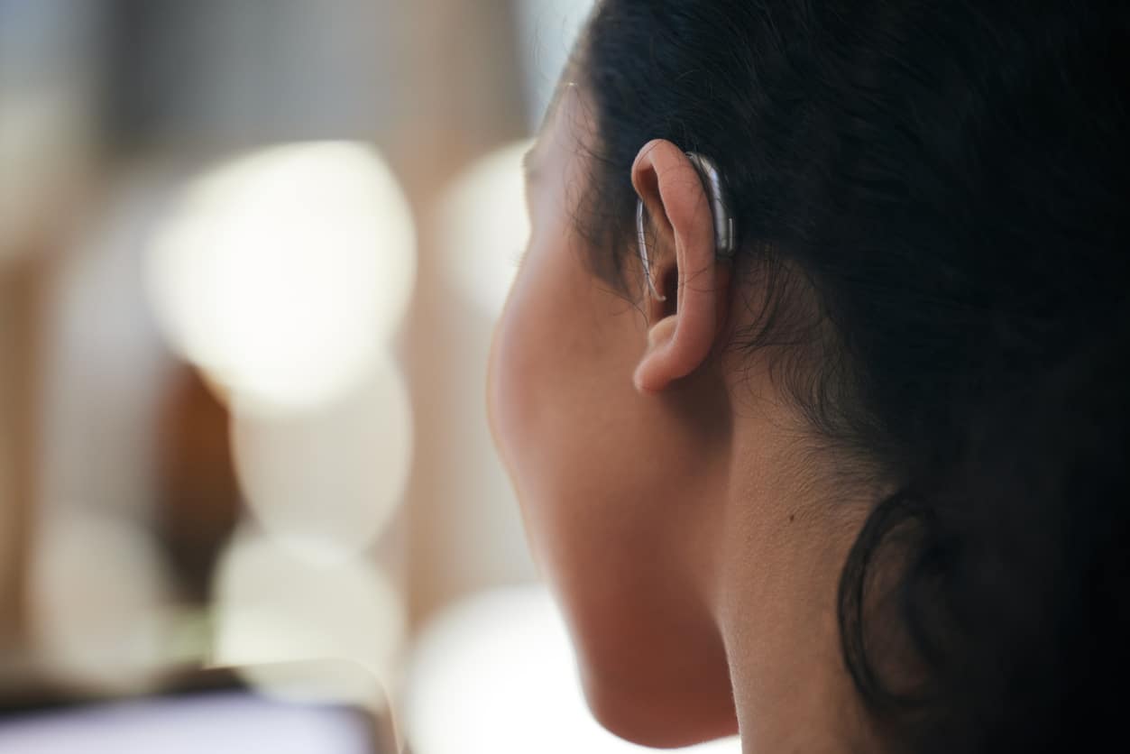 Close up of a hearing aid on an ear