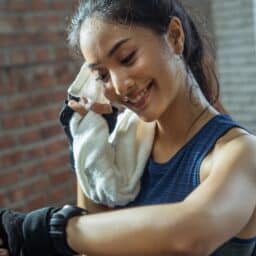 Woman smiles after a productive workout.