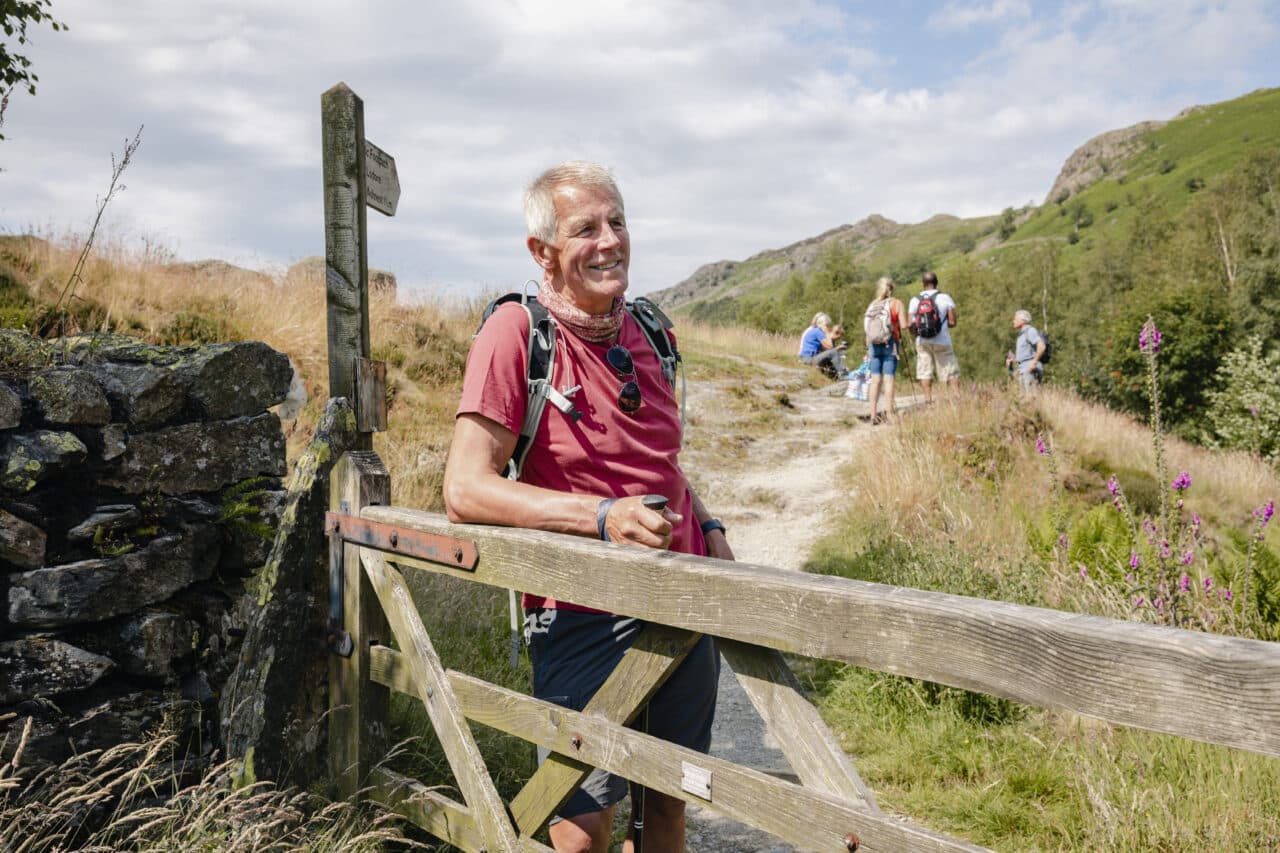 A man smiles after an intense hike.