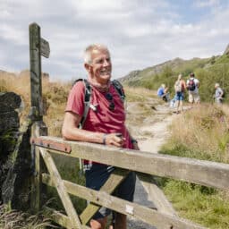 A man smiles after an intense hike.