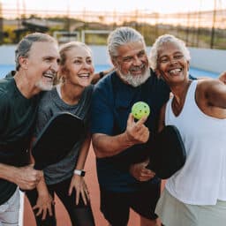 Group of friends taking a selfie after a pickleball match