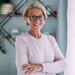 Happy, confident older woman smiles in her home.
