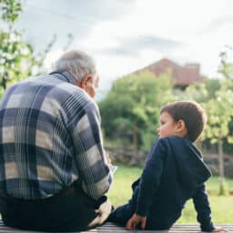 Shot of a great grandfather and his cute great grandson sitting on a bench.